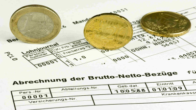 Lohnabrechnungs-Formular mit Euro-Münzen